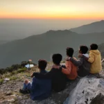 Friends at the George Everest summit at sunset