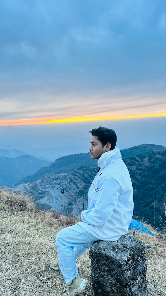 Person on rock at golden hour