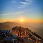 Prayer flags at the George Everest summit at sunrise