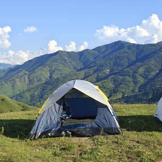 Tent among green mountains
