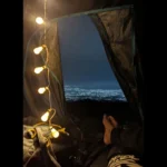 Inside a tent at Camp George Everest, with mattresses, sleeping bags and fairy lights