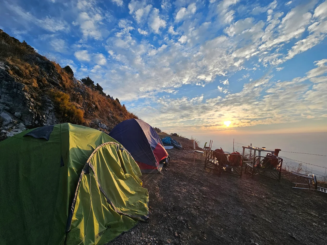 Tents under dramatic sunset clouds