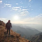 Walking the ridge towards George Everest Peak at sunset