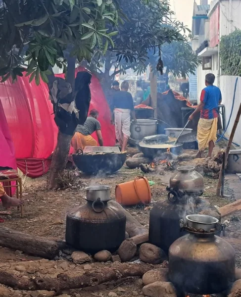 Large cauldrons simmering over a communal wood fire in a pahadi village kitchen