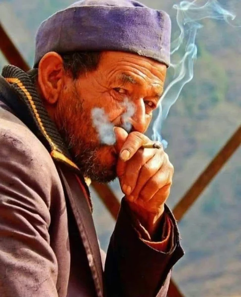 Elderly pahadi man wearing a traditional Kumaoni cap in the Himalayas