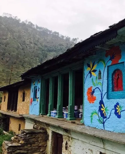 Hand-painted traditional pahadi village house with floral motifs in Uttarakhand