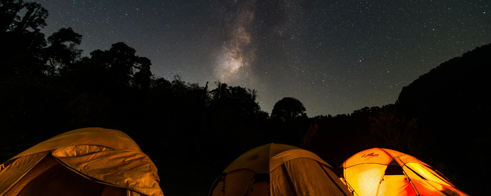 Bonfire flames dancing under the starry Himalayan night sky at Pahadi House