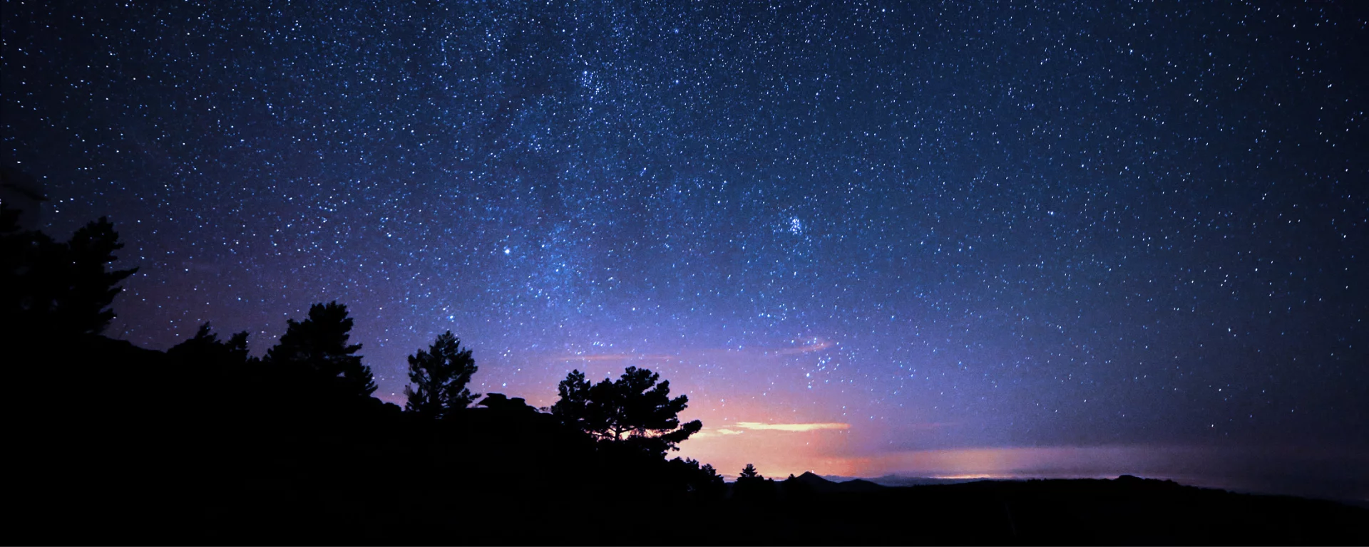Warm bonfire on the Pahadi House deck under a starry Himalayan night sky