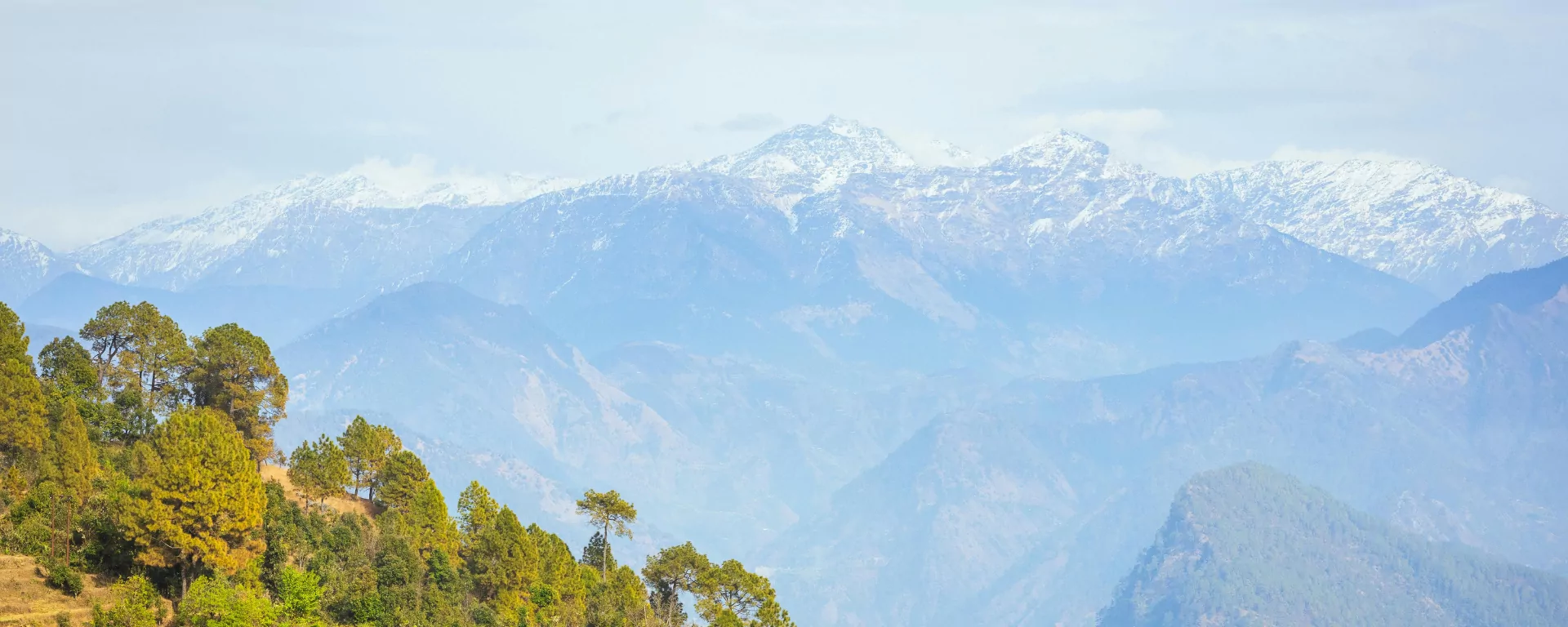 Hikers silhouetted on the summit ridge against sunrise