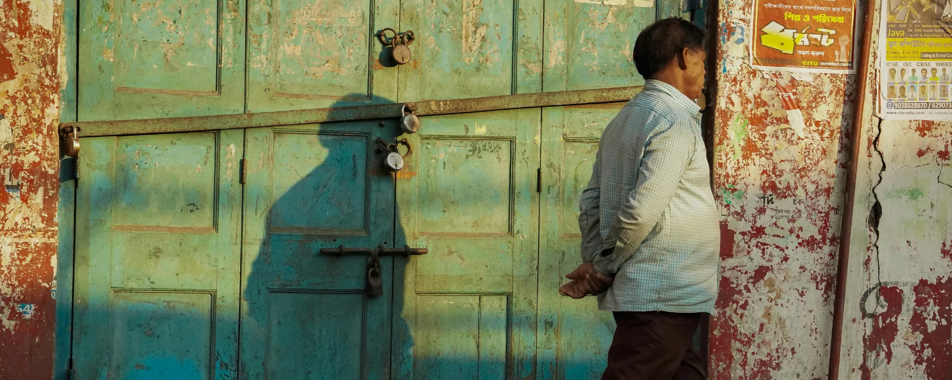 Elderly woman at the doorstep of a stone home