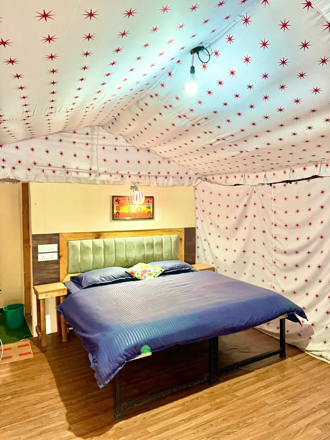 Cottage interior with queen bed at Himalayan Ganga Retreat, Rishikesh