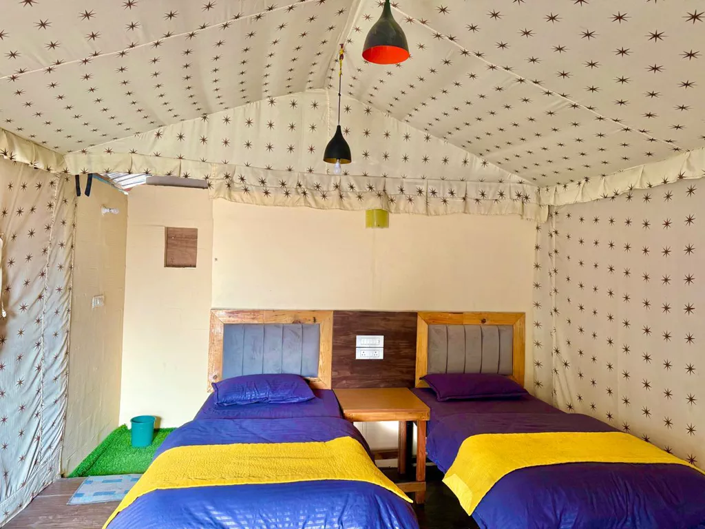 Deluxe AC tent interior with twin beds at Himalayan Ganga Retreat, riverside camp in Rishikesh