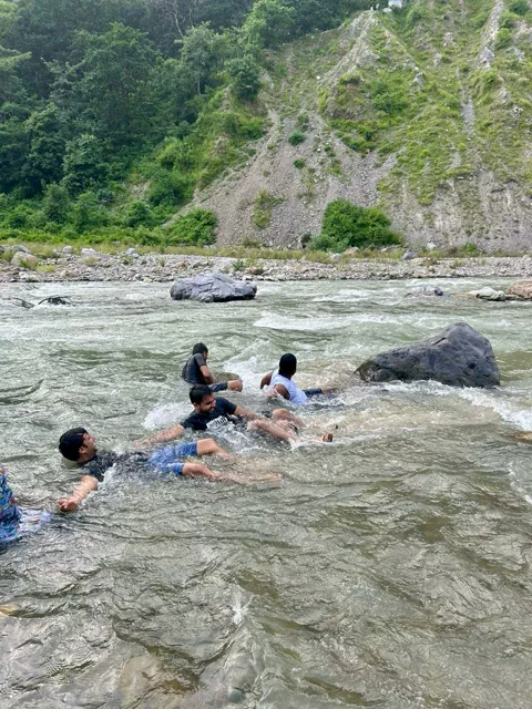 Group body-surfing in the Ganga near Himalayan Ganga Retreat, Rishikesh