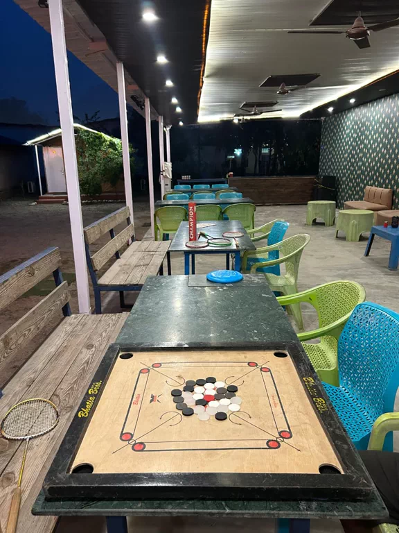 Indoor games area with carrom and badminton at the riverside camp in Rishikesh