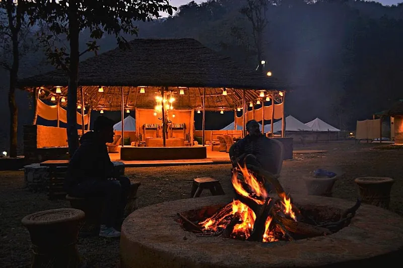 Family Forest Tent at Van Tarang, a forest retreat near Rajaji National Park, Rishikesh, outdoor seating at dusk