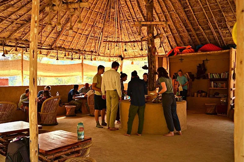 Bamboo and thatch lounge with stone and mud architecture at the Rajaji forest resort
