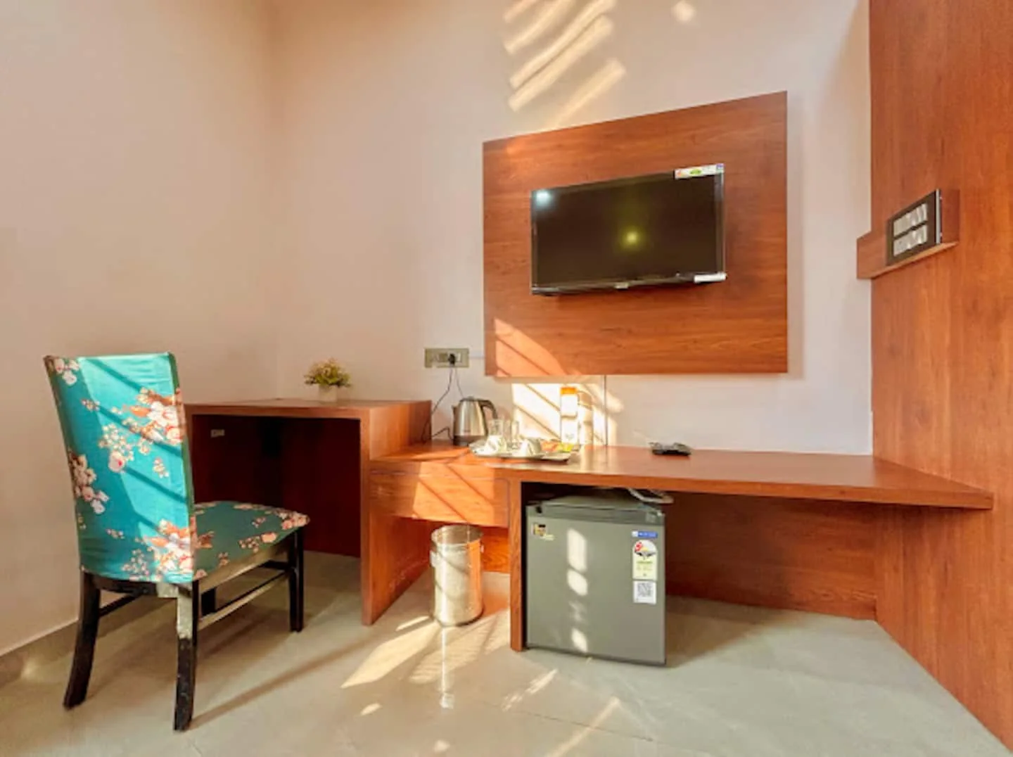 Dedicated workspace with TV and mini fridge at Prembasant Homestay, Rishikesh