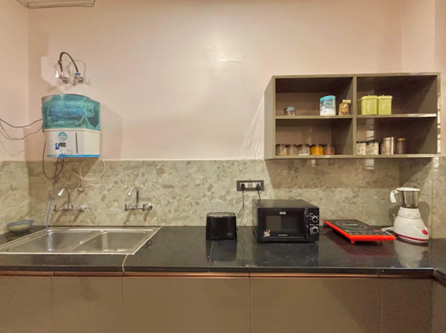 Guest kitchen with sink, oven and water purifier at Prembasant Homestay