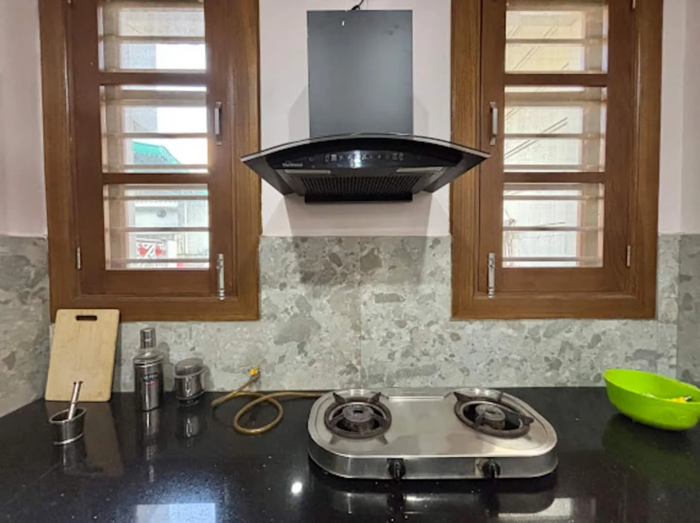 Kitchen with gas hob and chimney at Prembasant Homestay, Rishikesh