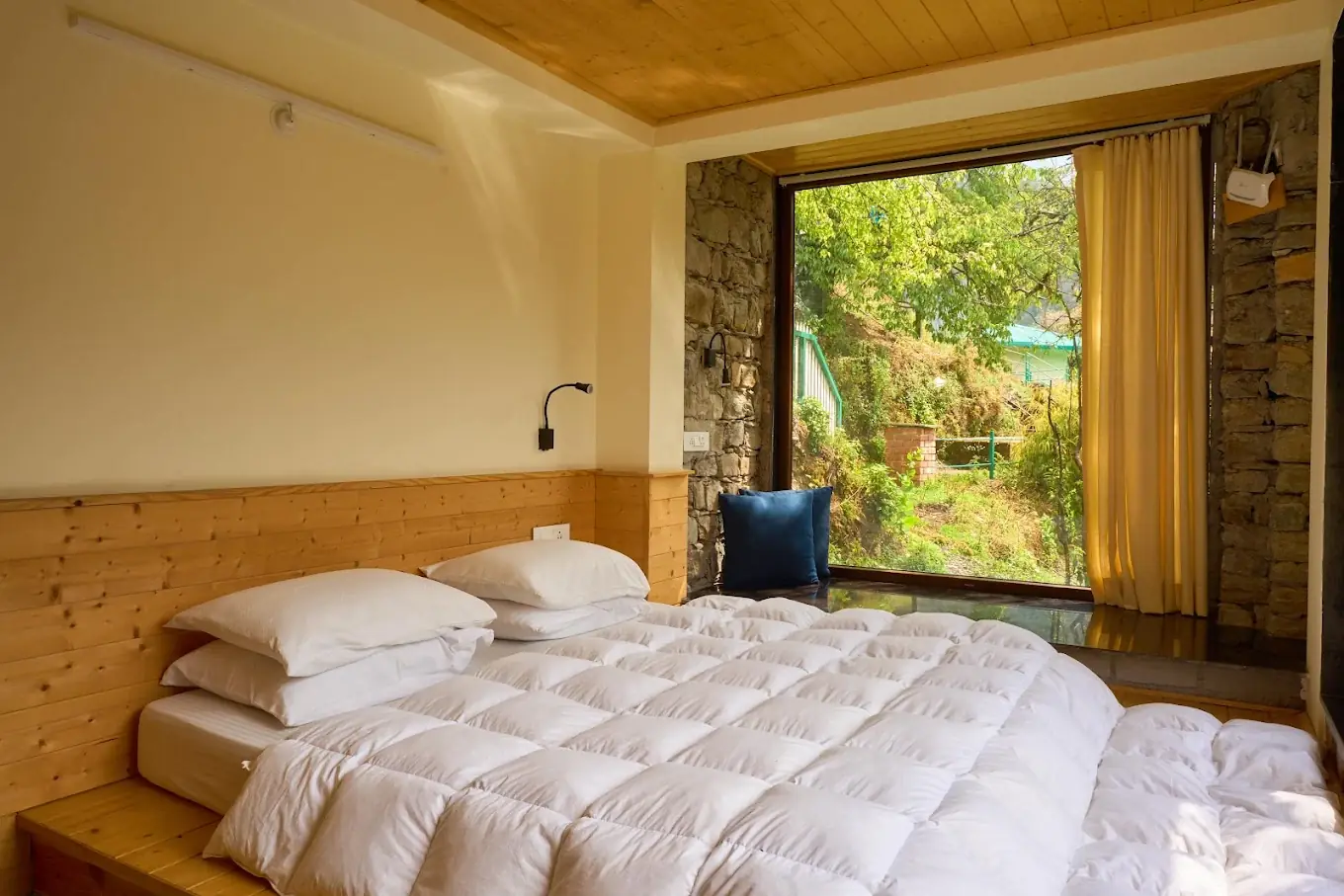 Deluxe room at Seegreen Homestay Mussoorie with a forest-facing window