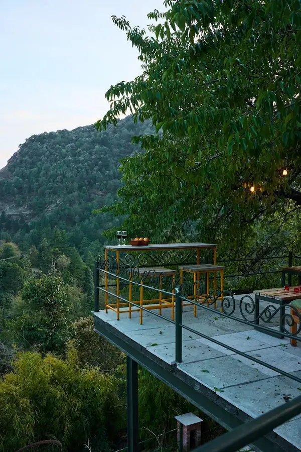 Rooftop cafe deck with tables and a valley view at Seegreen, Mussoorie