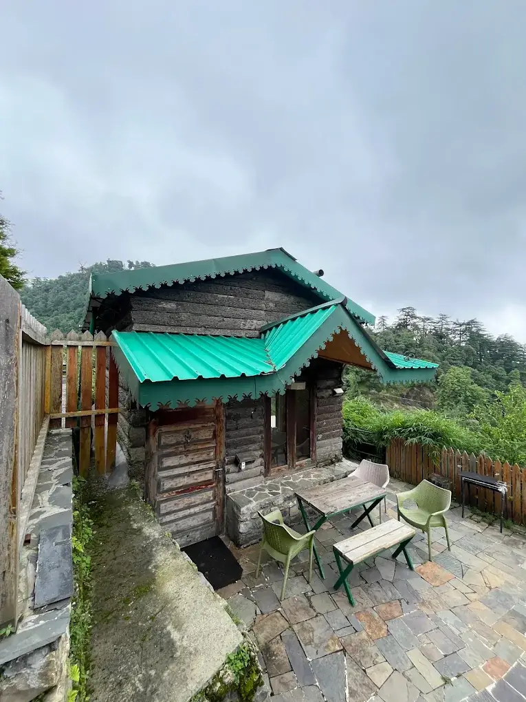 Log hut cabin with outdoor seating at Seegreen Mussoorie