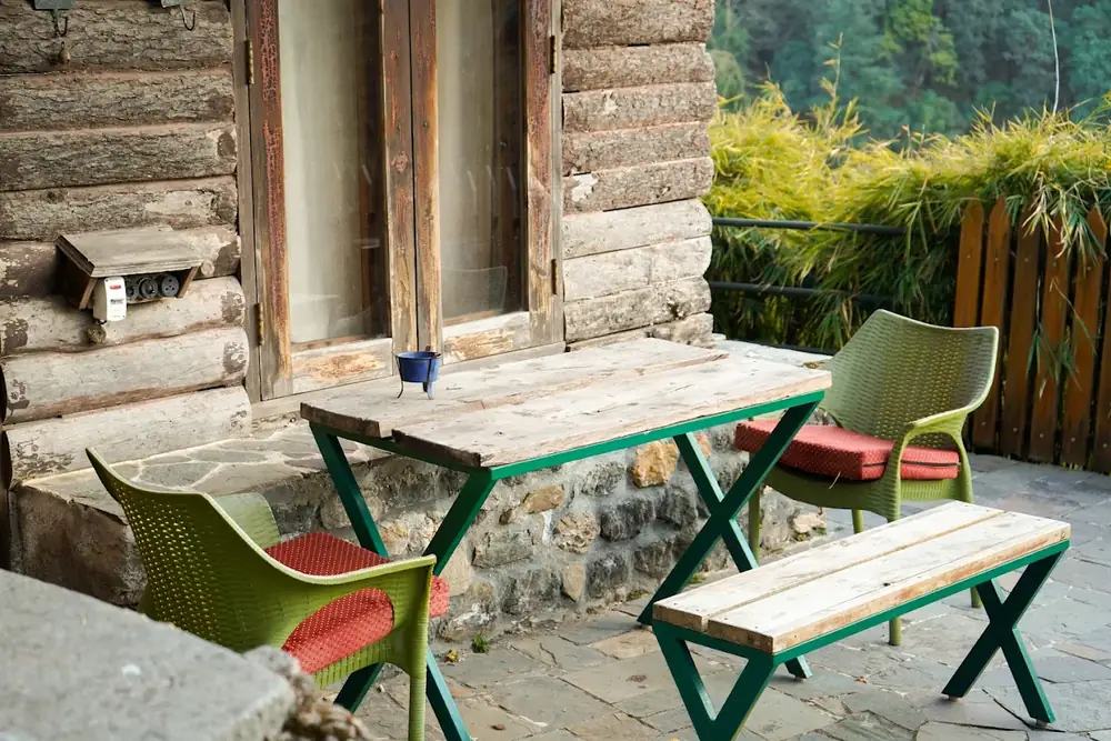 Log cabin and cafe bench seating at Seegreen Lodges, Mussoorie