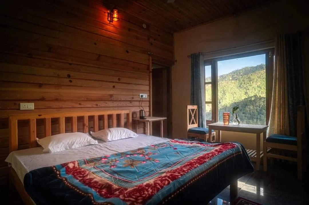 Wood panelled room with a window onto the valley at Aa Maa's Homestay, Mukteshwar