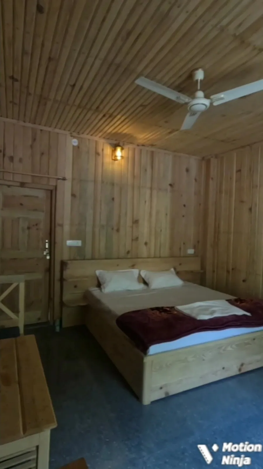 Bedroom with wooden walls and ceiling at Aa Maa's Homestay, Mukteshwar