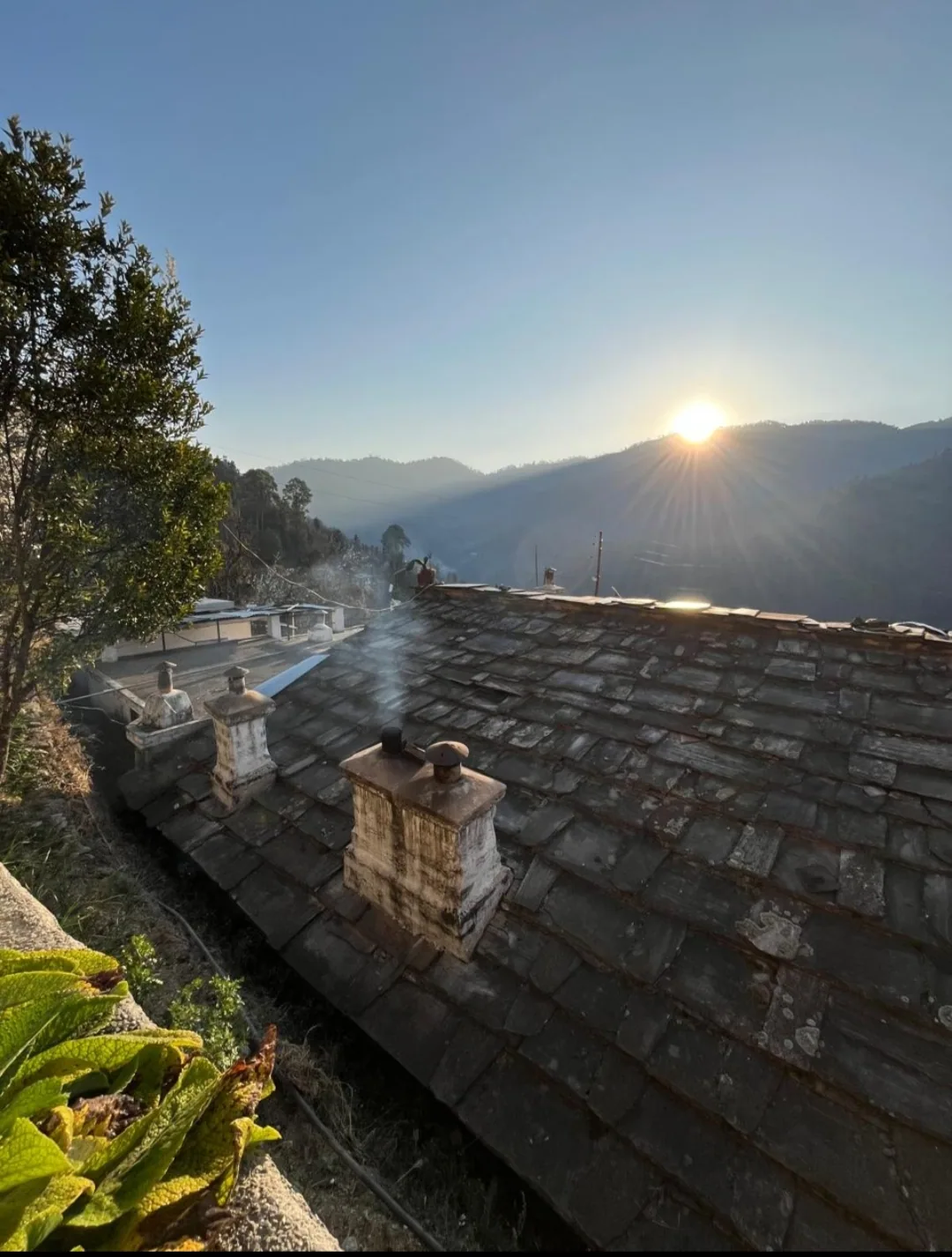 Moonrise over the slate roofs of Pangrari village, Mukteshwar