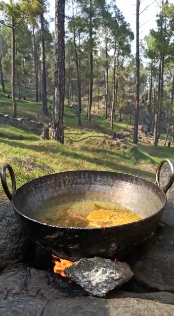 Cooking in a kadhai over wood at Aa Maa's Homestay, Mukteshwar
