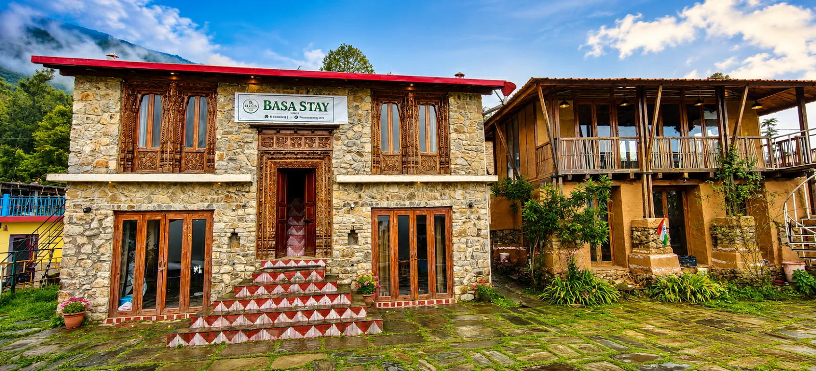 Basa Stay at Khirsu, a stone and timber Garhwali house with a slate roof and pine forest behind