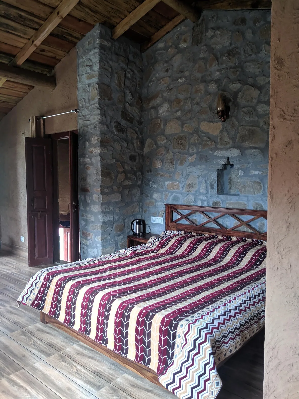 Carved wooden doorway and window frames at Basa Stay, Khirsu