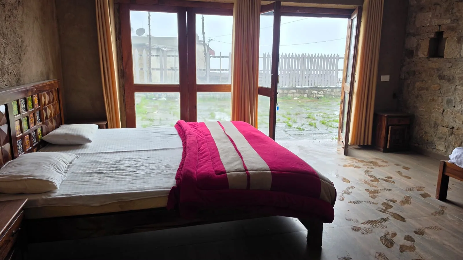 Twin bedded room with windows onto the hillside at Basa Stay, Khirsu