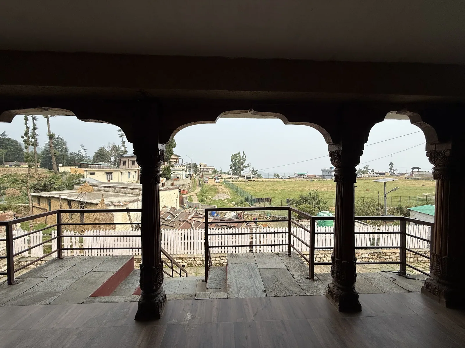 Carved stone pillars along the verandah at Basa Stay, Khirsu