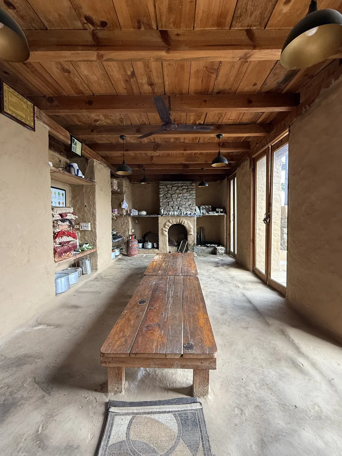 Common room with a long wooden table at Basa Stay, Khirsu