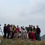 A group with the camp telescope on the ridge at Camp George Everest, Mussoorie