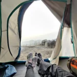 Looking out from inside a tent at Camp George Everest towards the ridge