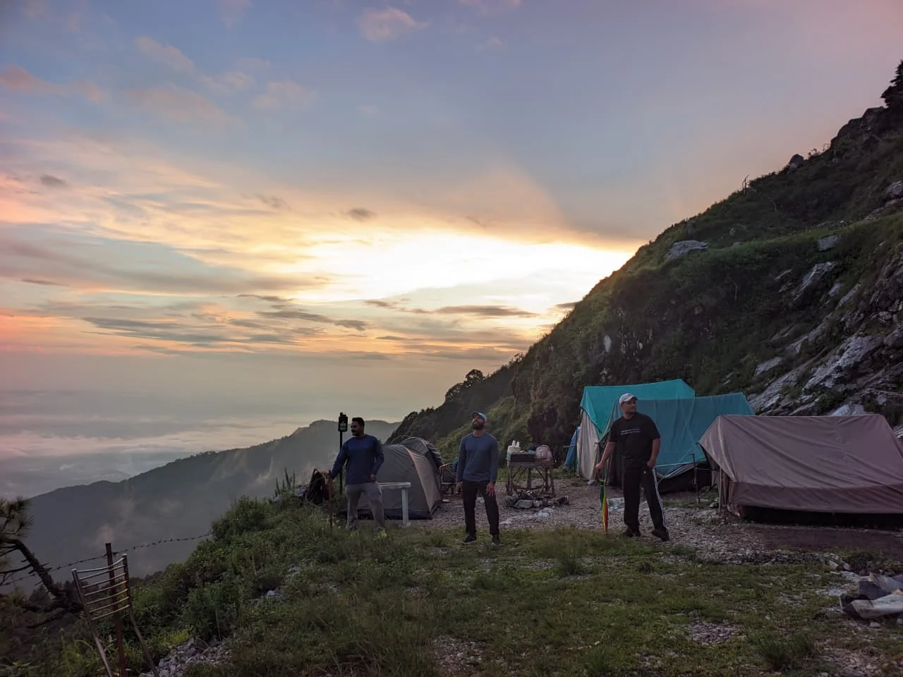 Tents on the ridge at Camp George Everest at first light, above a sea of cloud over the Doon Valley