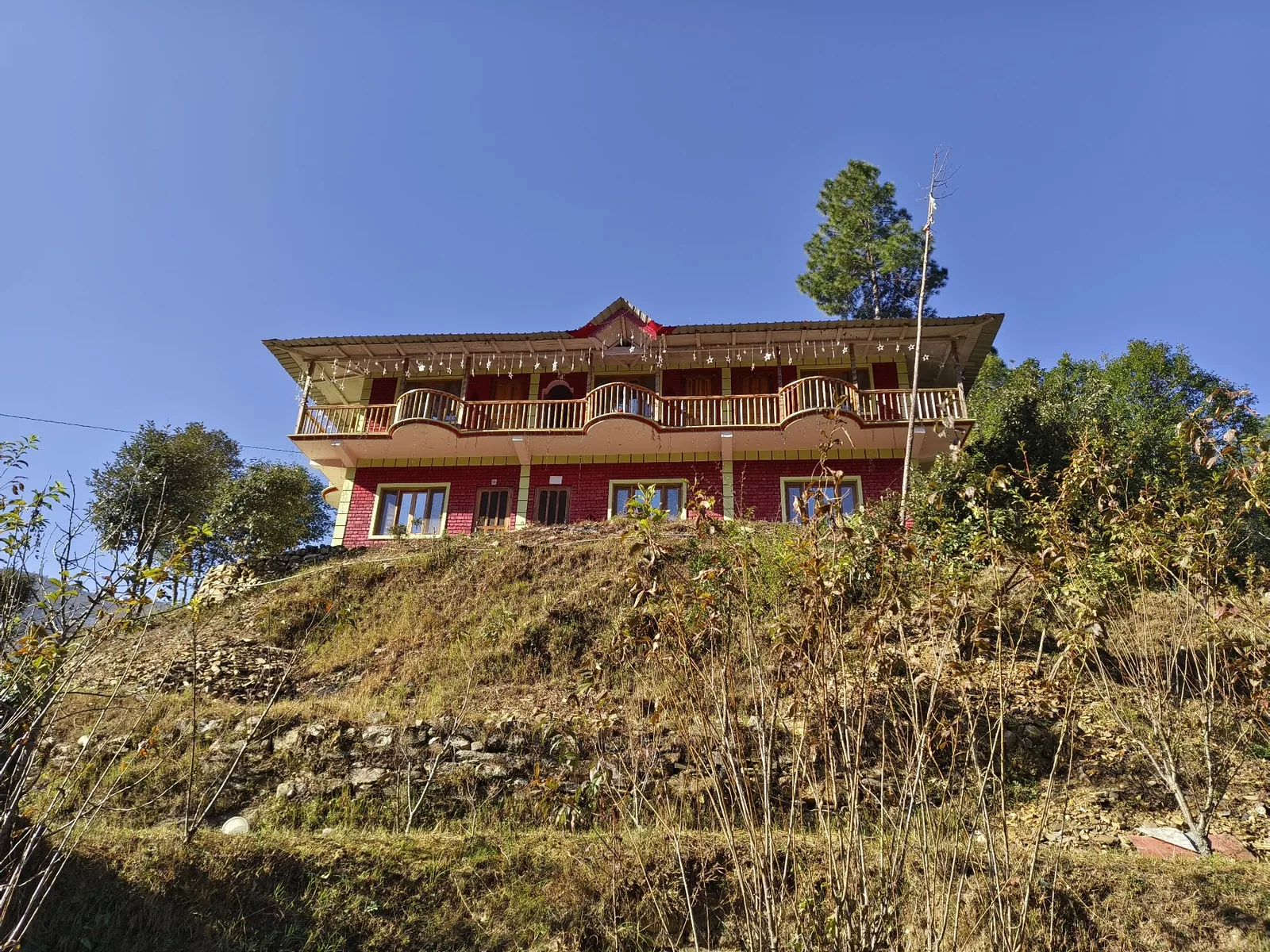 The Ghughuti Homestay building above the fields at Sunkiya, Mukteshwar