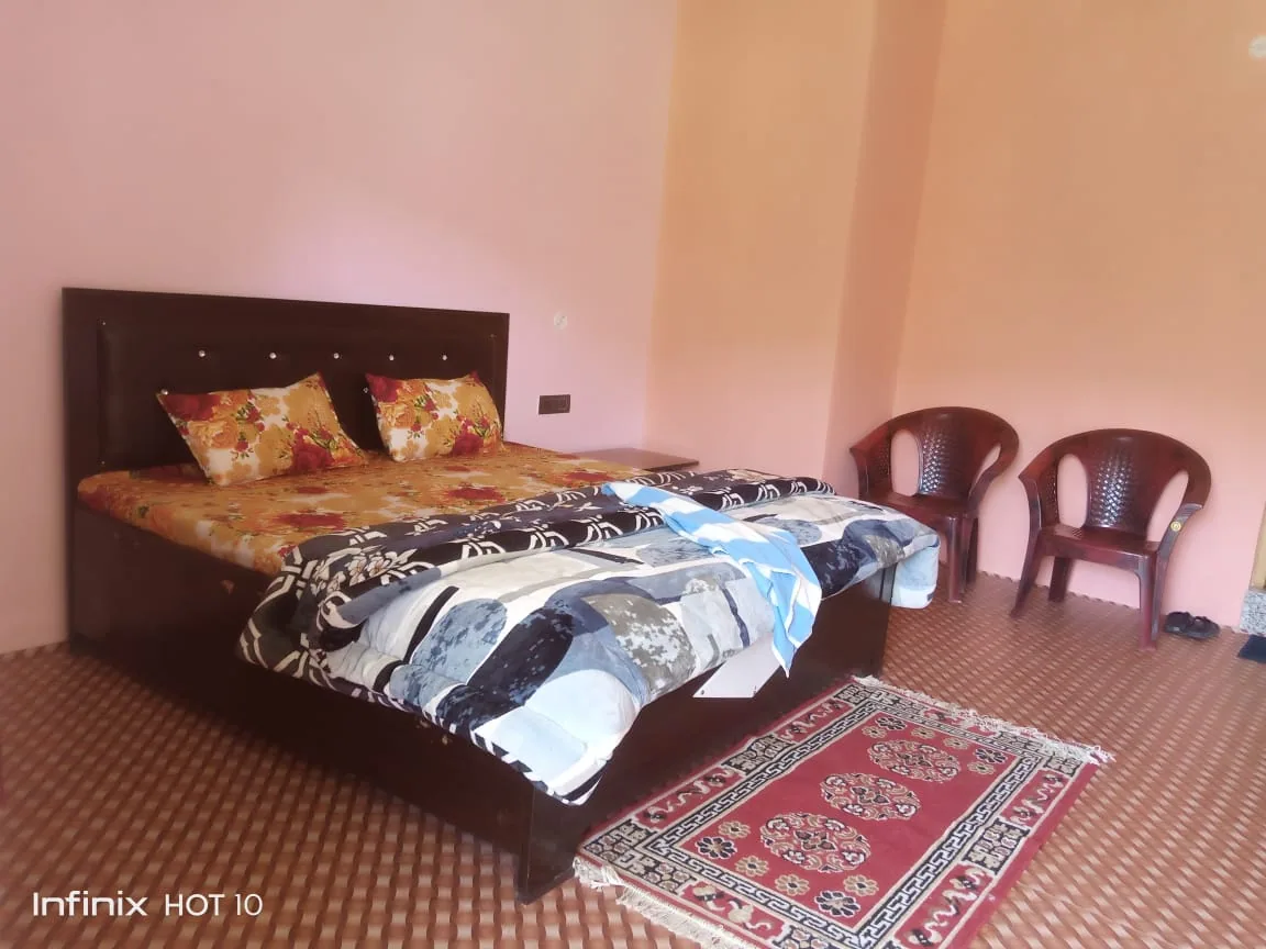 Bedroom with a double bed at Ghughuti Homestay, Sunkiya