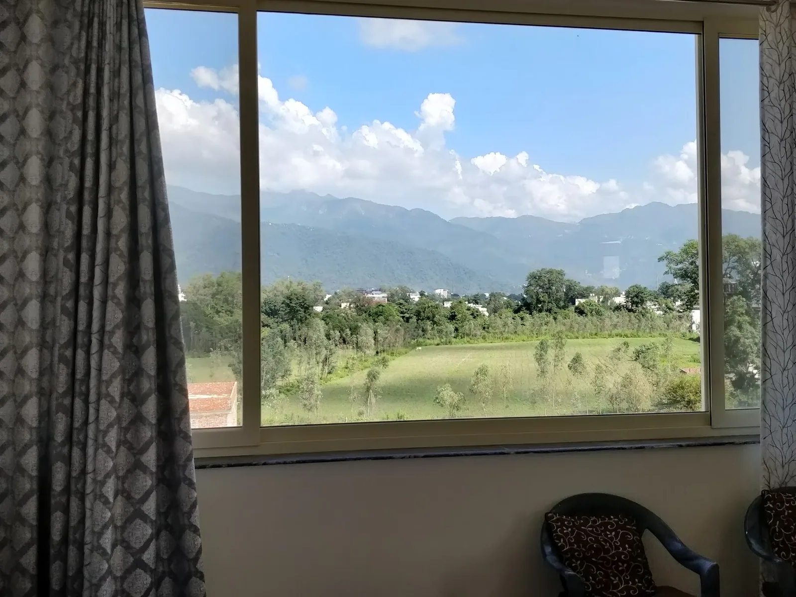 Fields and hills seen from the room at Little Sparrow Homestay, Rishikesh