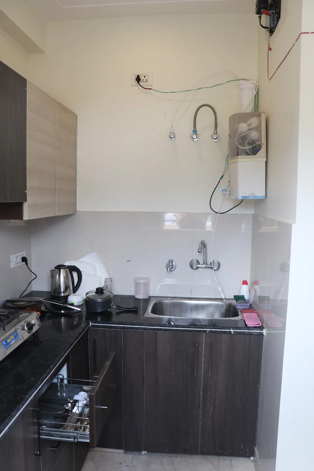 Kitchen with a sink, hob and kettle at Little Sparrow Homestay, Rishikesh