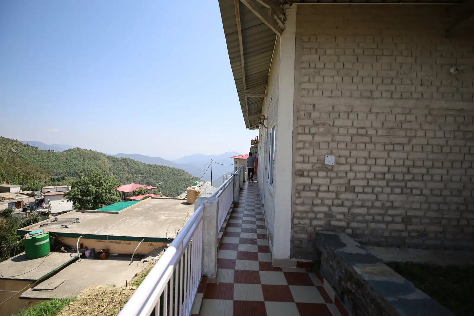 Walkway running along the cottages with valley views