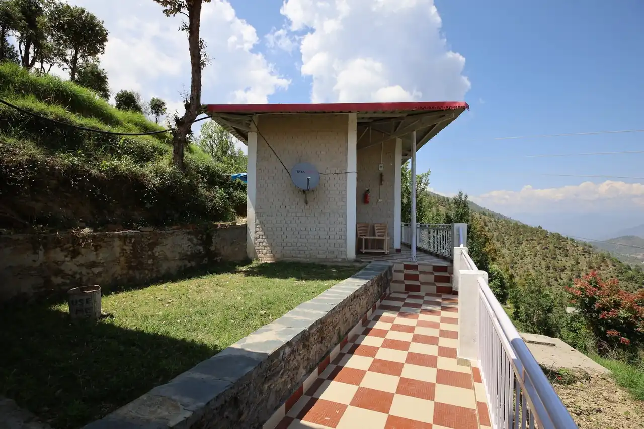 Sit-out shelter with the Himalayan range behind it