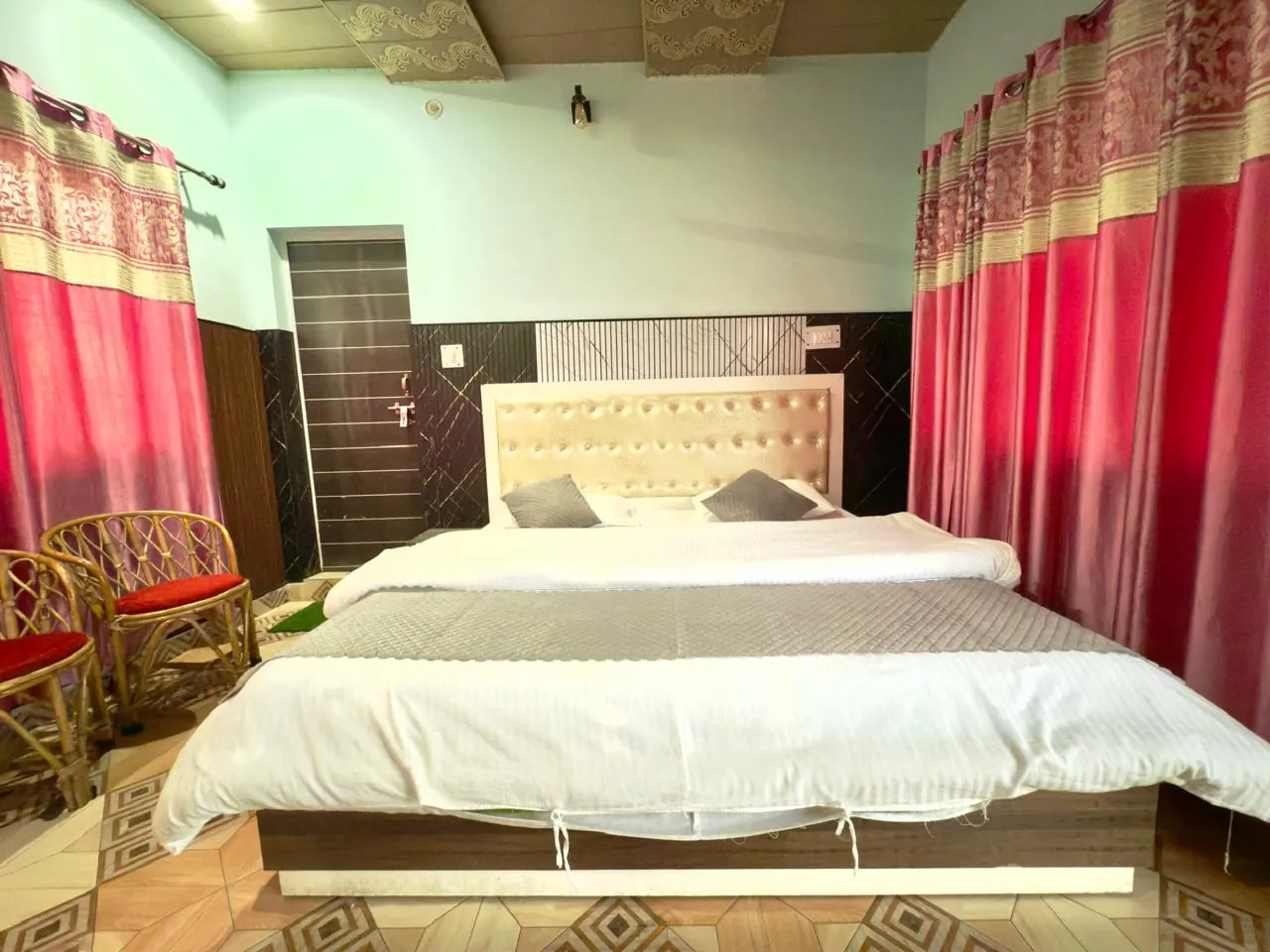 Room with cane seating and mountain-facing curtains