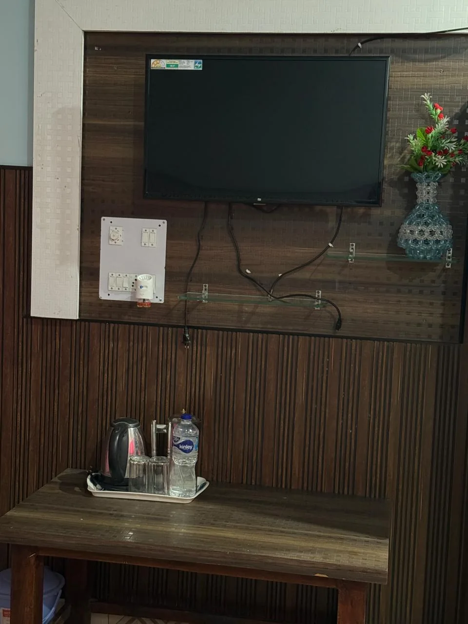 Tea and coffee tray with electric kettle in the room