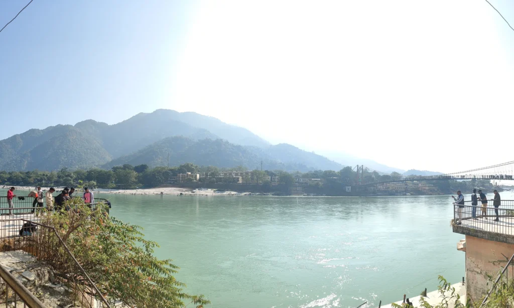 The Ganga at Rishikesh with the Shivalik hills behind, the setting for the town's family resorts