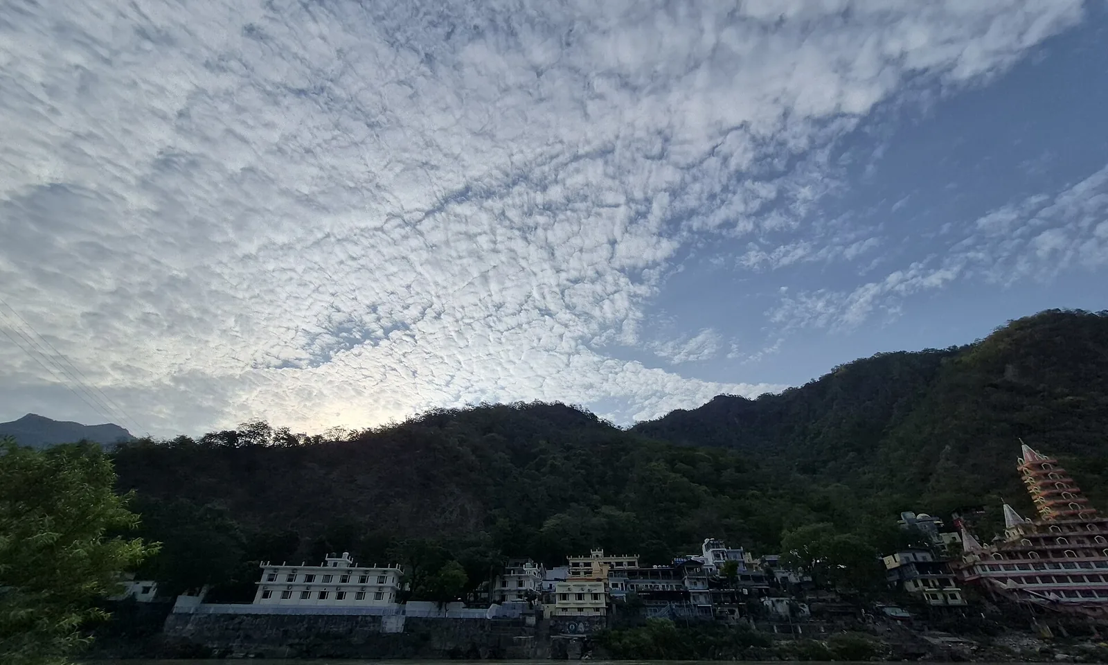 Tapovan ghats and the Tryambakeshwar temple below forested hills at Rishikesh