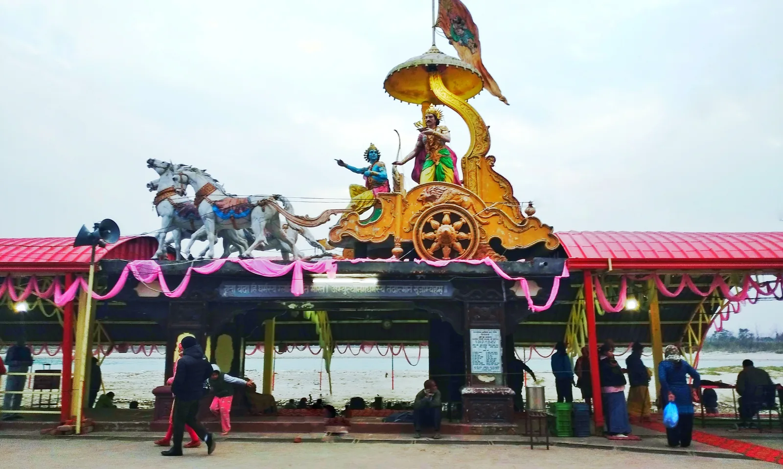 The riverfront at Triveni Ghat in Rishikesh town with the Arjuna and Krishna chariot sculpture